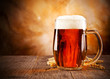 Photo: Glass of beer on wooden table Glass of beer on wooden table