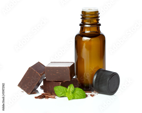 Photo: essential oil essential and chocolate with mint leaves isolated essential oil essential and chocolate with mint leaves isolated