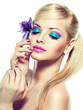 Blonde model with fashion make-up and violet manicure