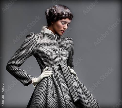 Photo: Nostalgia. Romantic Lady in Classic Coat. Pinup Style Nostalgia. Romantic Lady in Classic Coat. Pinup Style