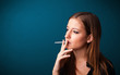 Beautiful woman smoking cigarette vith copy space
