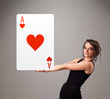 Beautifu woman holding a red heart ace