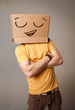 Young man gesturing with a cardboard box on his head with smiley
