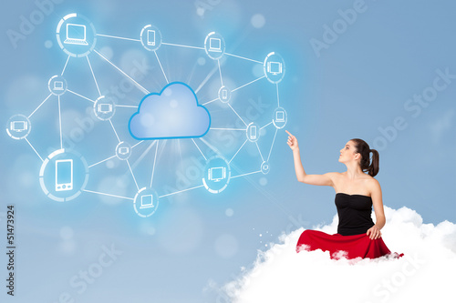 Photo: Happy woman sitting on cloud with cloud computing Happy woman sitting on cloud with cloud computing