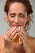 Beautiful woman in towel with herbal tea