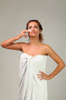 Beautiful woman with cream on face