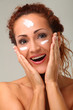 Beautiful woman with cream on face