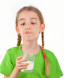 Little girl drinks milk from a glass