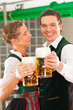 Foto: Man and woman with beer glass in brewery Man and woman with beer glass in brewery