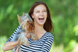 Foto: woman beautiful young holds small dog woman beautiful young holds small dog