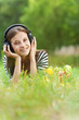 Photo: woman listening to music through headphones woman listening to music through headphones