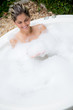 Happy woman taking a bath