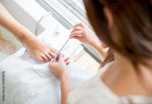 Photo: Woman giving a pedicure Woman giving a pedicure
