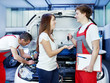 Key delivery between customer and mechanic in front of a car