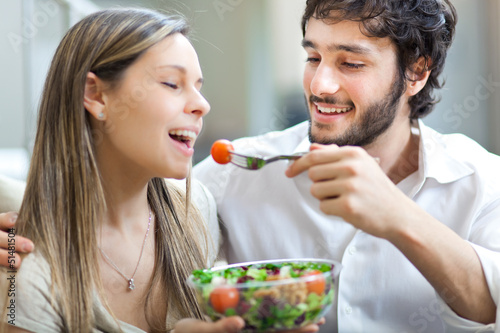 Photo: Happy couple eating a salad Happy couple eating a salad