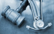 Gavel and stethoscope on wooden background