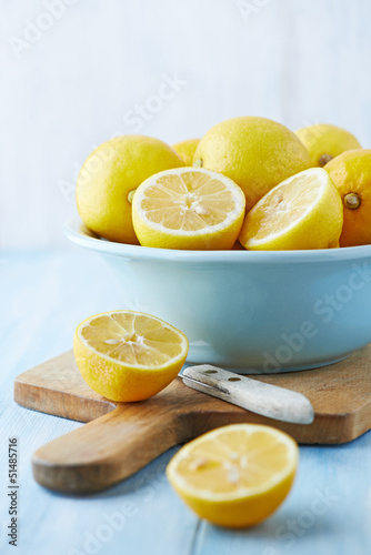 Photo: Fresh lemons in a bowl; whole and halved Fresh lemons in a bowl; whole and halved