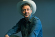 Retro cowboy with white hat. Studio shot.
