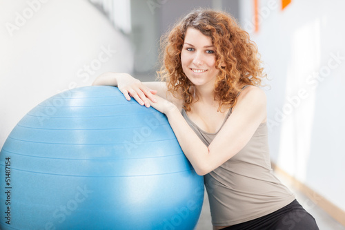 Photo: Young woman doing exercise with a gym ball Young woman doing exercise with a gym ball