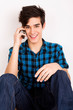 Young man talking on the phone at home