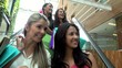 Shopping women on escalators