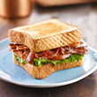 Photo: BLT bacon lettuce tomato sandwich on blue plate BLT bacon lettuce tomato sandwich on blue plate