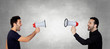 Two Young Men Shouting Through Megaphone