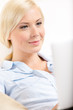 Close up view of woman sitting with silver laptop