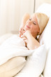 Photo: Woman stretches herself lying in bed in the morning at weekend Woman stretches herself lying in bed in the morning at weekend