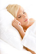Close up shot of sleepy woman in bed lying on the white cushion