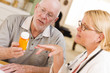 Doctor or Nurse Explaining Prescription Medicine to Senior Man