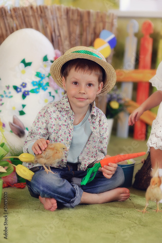 Photo: it's a wonderful boy in a straw hat with a chicken and carrots it's a wonderful boy in a straw hat with a chicken and carrots