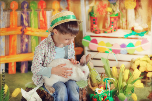 Photo: Easter theme with small boy with bunnies, chicks and eggs Easter theme with small boy with bunnies, chicks and eggs