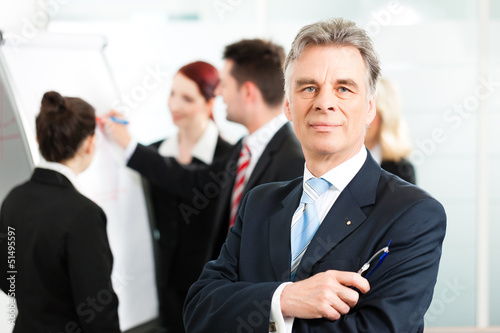 Photo: Business Team with leader in office Business Team with leader in office