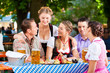 In Beer garden - friends on a table with beer