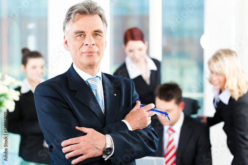 Photo: Business Team with leader in office Business Team with leader in office