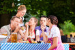 Foto: In Beer garden - friends on a table with beer In Beer garden - friends on a table with beer