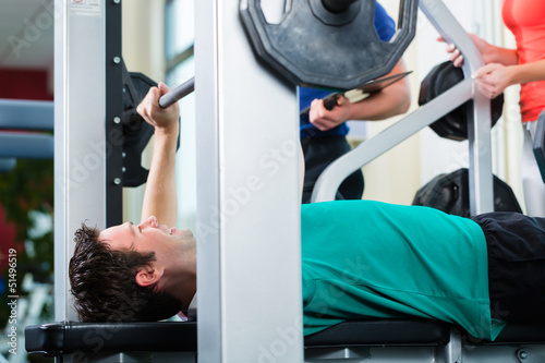 Photo: Man and Personal Trainer in gym Man and Personal Trainer in gym