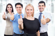 Business people showing thumbs up sign