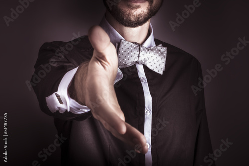 Photo: Polite sophisticated man offering his hand Polite sophisticated man offering his hand