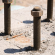 a close look of bolts fixed on concrete