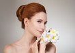 Beauty face of the young beautiful woman with flower.