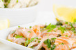 Salmon carpaccio (fresh salmon slices in marinade) with potato s