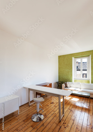 Photo: home interior, view of studio with white sofa and desk home interior, view of studio with white sofa and desk