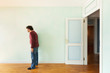portrait of a weird guy in the room with the door open