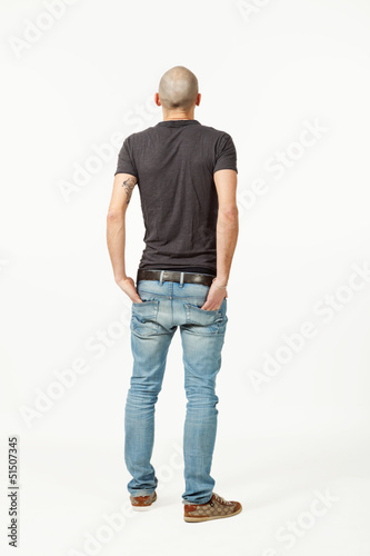 Photo: portrait of young man in studio, back view portrait of young man in studio, back view
