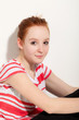 portrait of cute redheaded girl, background wall