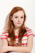 portrait of cute redheaded girl, background wall