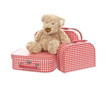 three vintage red and white suitcases with teddy bear