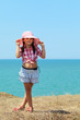 Girl holds on to her hat